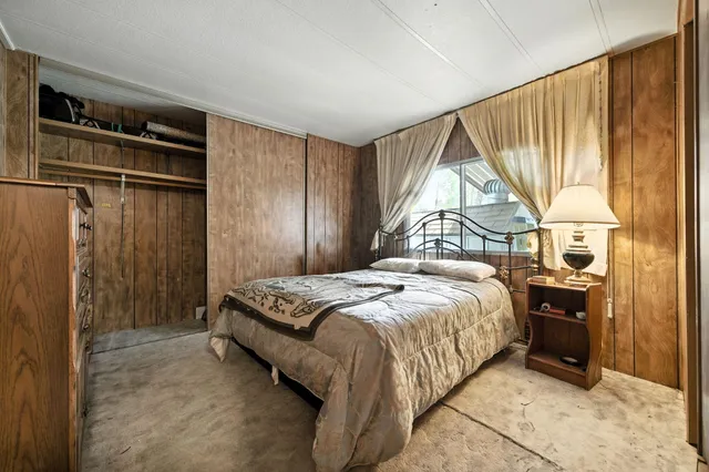 a bedroom with a bed and a window