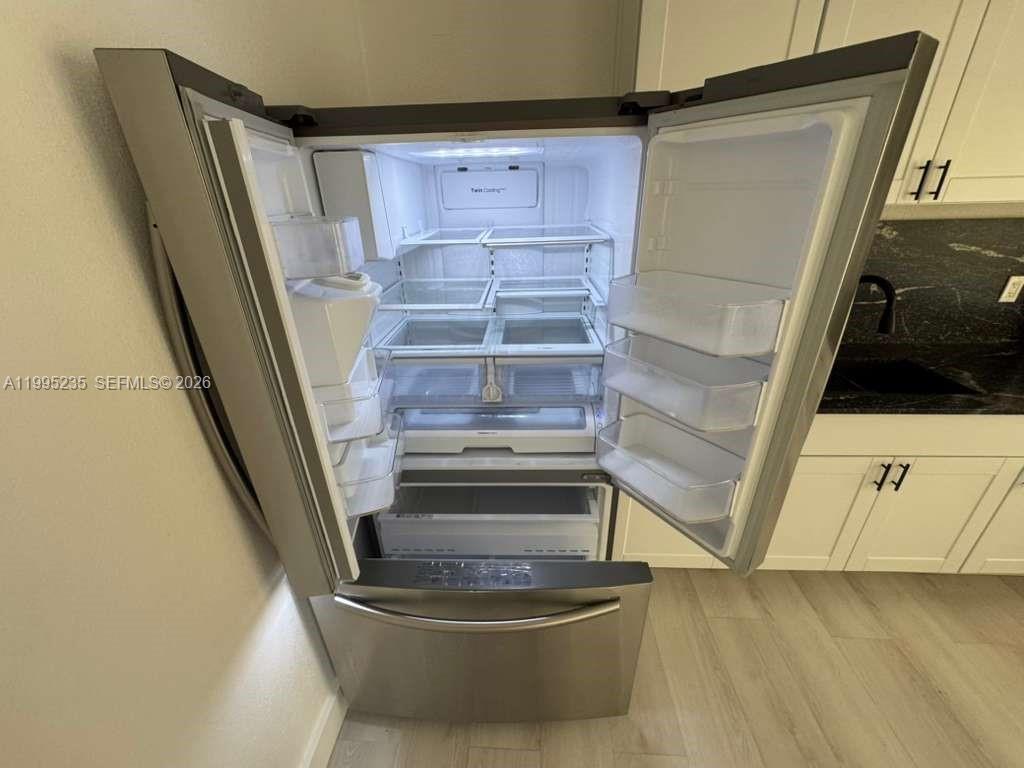 230 East 56th Street, Unit A Hialeah, FL 33013 - Photo 14 of 25 a view of walk in closet with empty racks