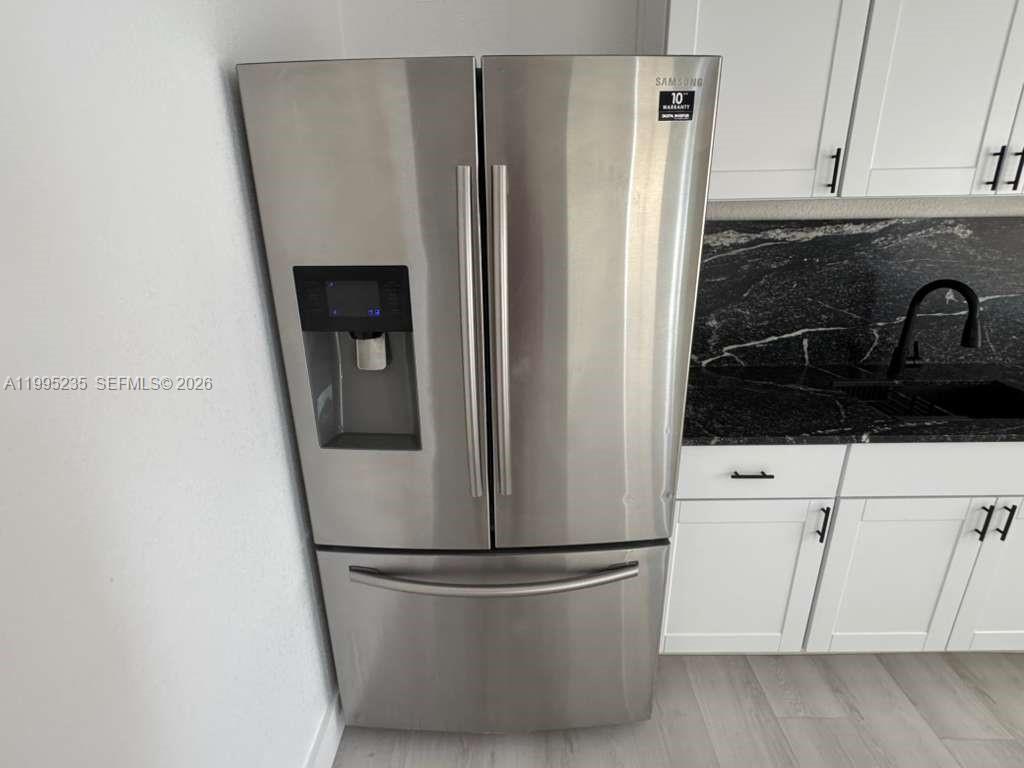 230 East 56th Street, Unit A Hialeah, FL 33013 - Photo 15 of 25 a white refrigerator freezer sitting inside of a kitchen