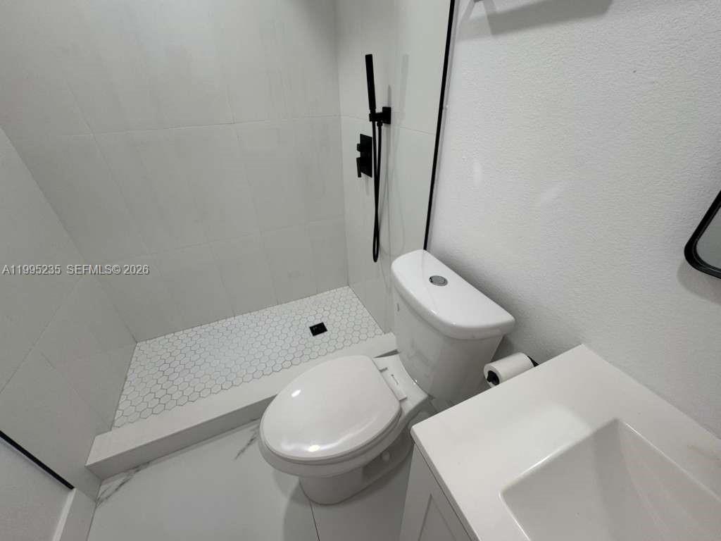 230 East 56th Street, Unit A Hialeah, FL 33013 - Photo 18 of 25 a bathroom with a sink and toilet