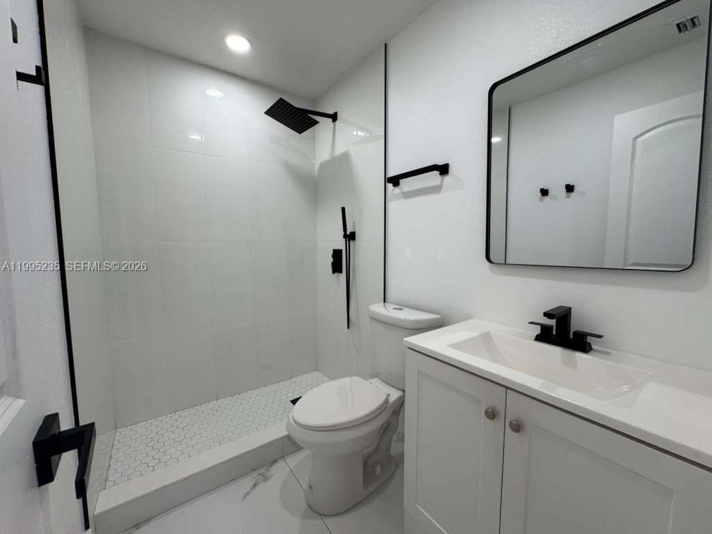 230 East 56th Street, Unit A Hialeah, FL 33013 - Photo 19 of 25 a bathroom with a sink toilet and shower