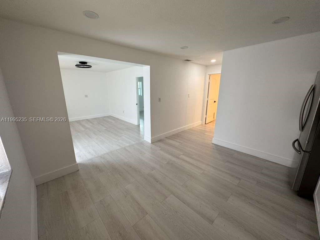 230 East 56th Street, Unit A Hialeah, FL 33013 - Photo 20 of 25 wooden floor in an empty room