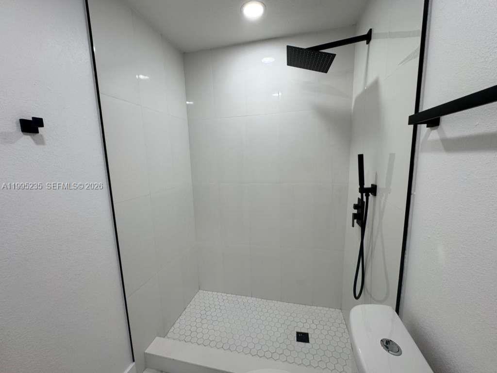 230 East 56th Street, Unit A Hialeah, FL 33013 - Photo 21 of 25 a bathroom with a shower and a toilet