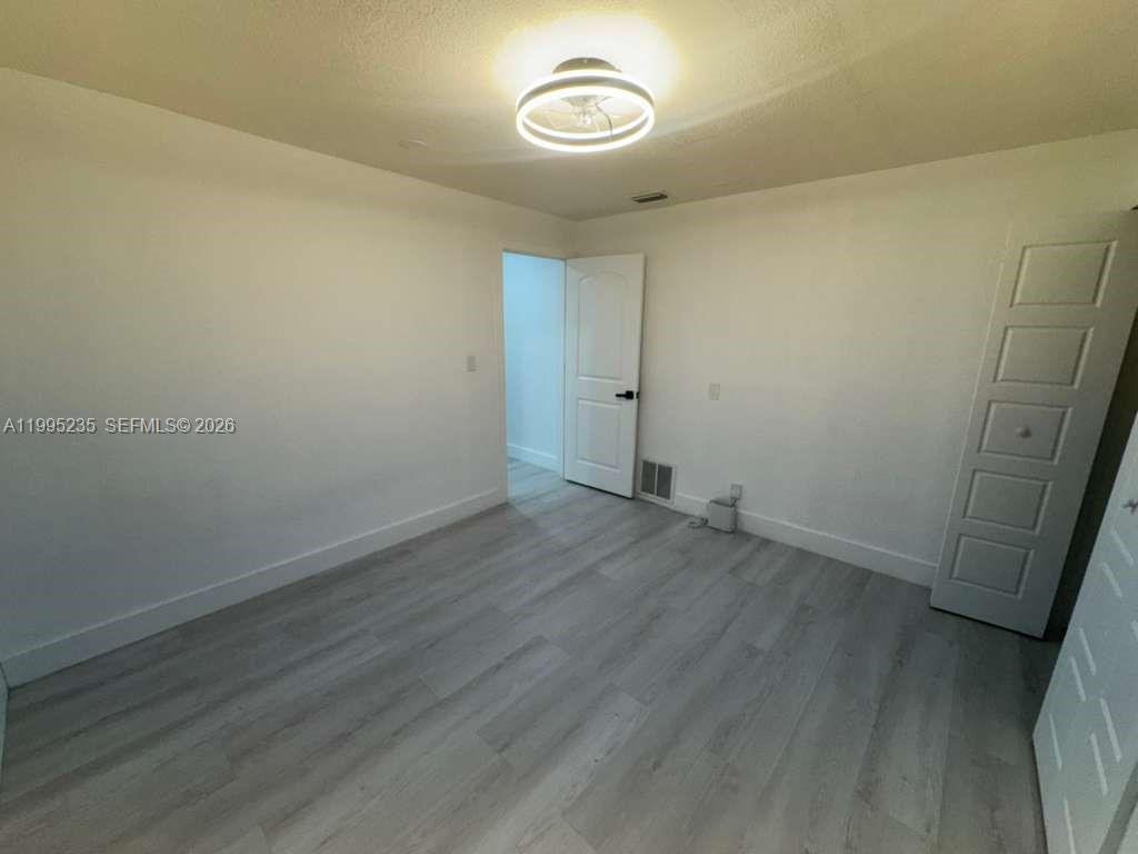 230 East 56th Street, Unit A Hialeah, FL 33013 - Photo 25 of 25 a view of a room with wooden floor