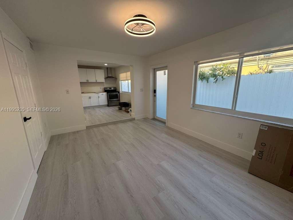 230 East 56th Street, Unit A Hialeah, FL 33013 - Photo 4 of 25 a view of a room with wooden floor and window