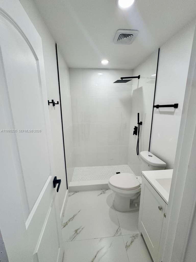 230 East 56th Street, Unit A Hialeah, FL 33013 - Photo 6 of 25 a bathroom with a toilet sink and a shower