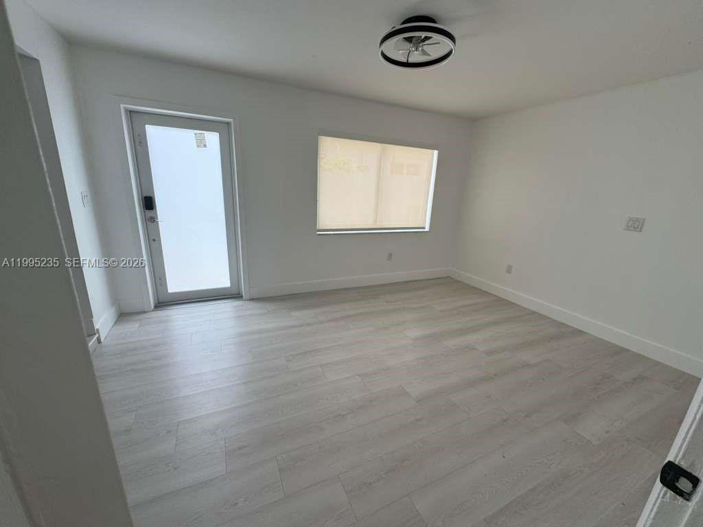 230 East 56th Street, Unit A Hialeah, FL 33013 - Photo 7 of 25 an empty room with a window