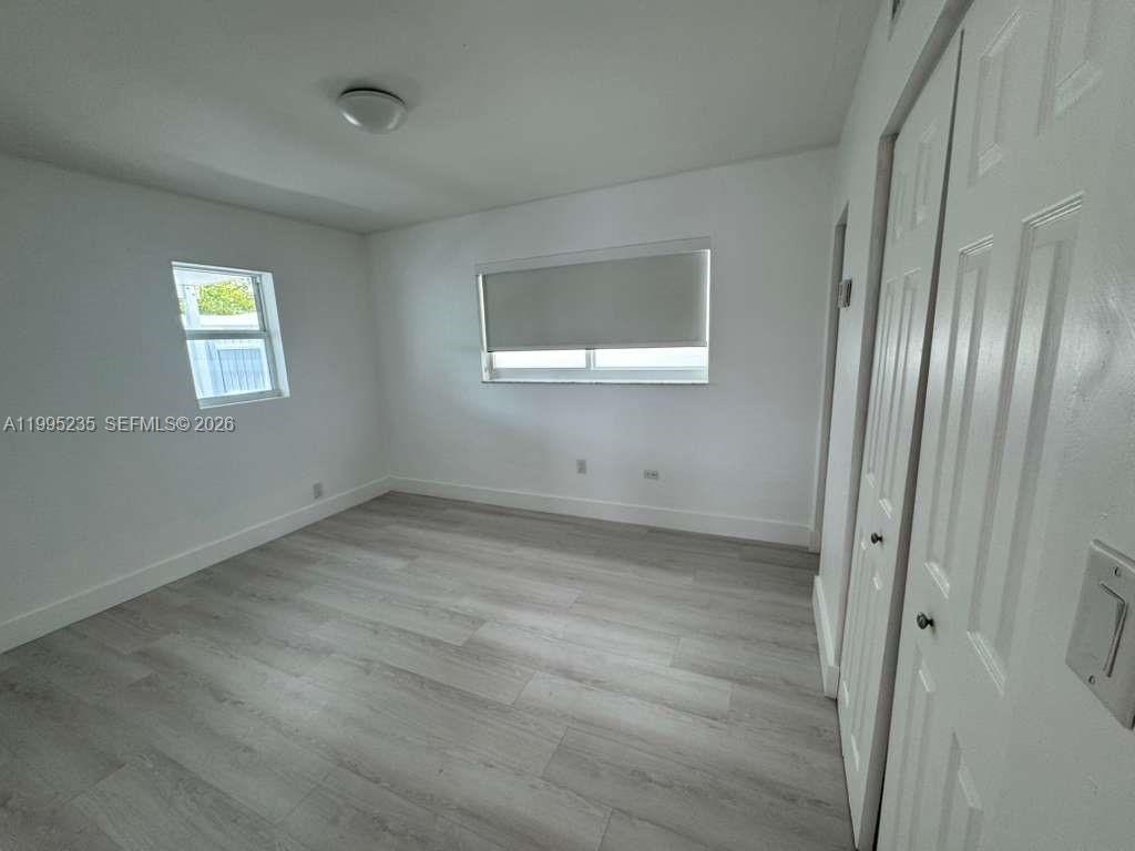 230 East 56th Street, Unit A Hialeah, FL 33013 - Photo 8 of 25 a view of an empty room with a window