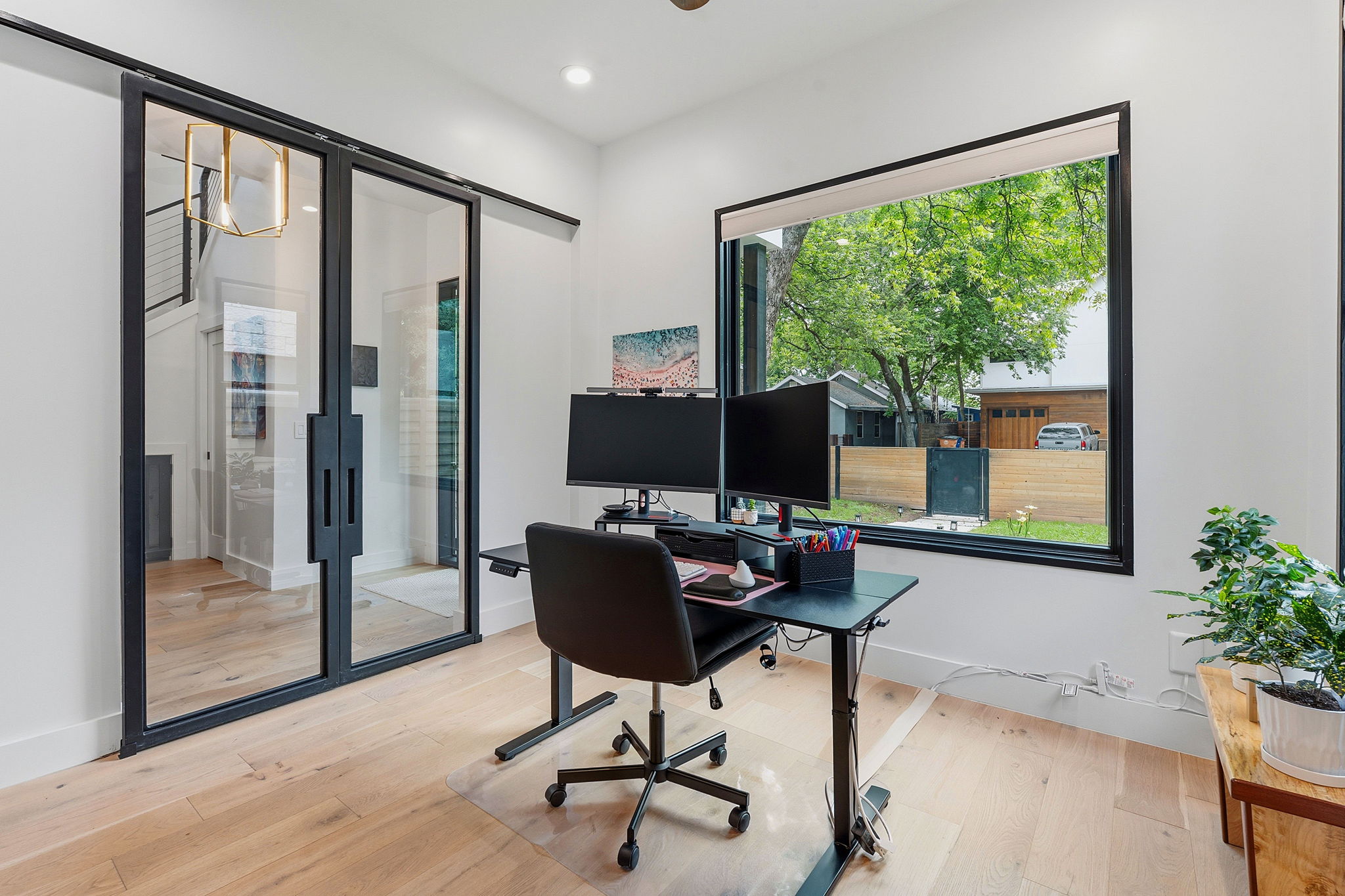 2004 Riverview Street Austin, TX 78702 - Photo 16 of 36 Light wood-finish flooring complements white walls and a large picture window with black framing