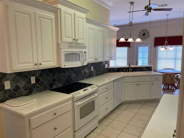 a kitchen with stainless steel appliances a refrigerator and cabinets