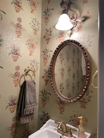 a kitchen with white cabinets and sink