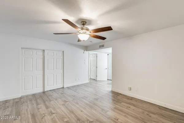 a living room with furniture and a ceiling fan