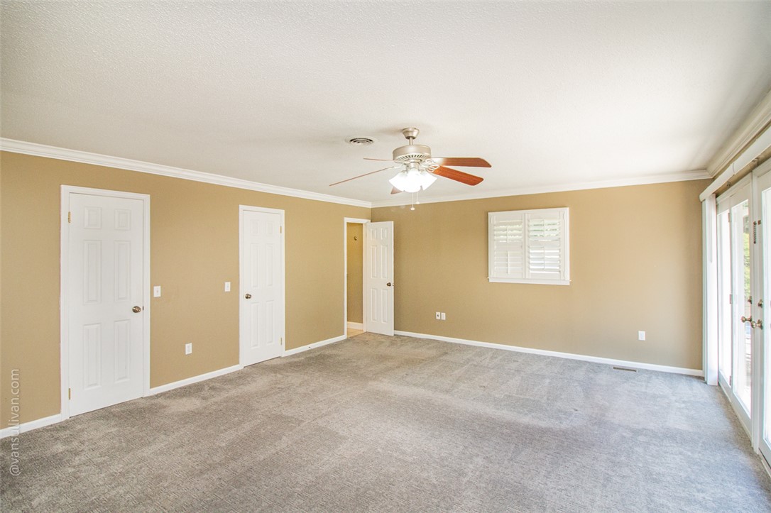 4518 Cove Trail Anderson, SC 29621 - Photo 20 of 49 Plentiful natural light streams through glass doors into a well-proportioned primary bedroom with crown molding.