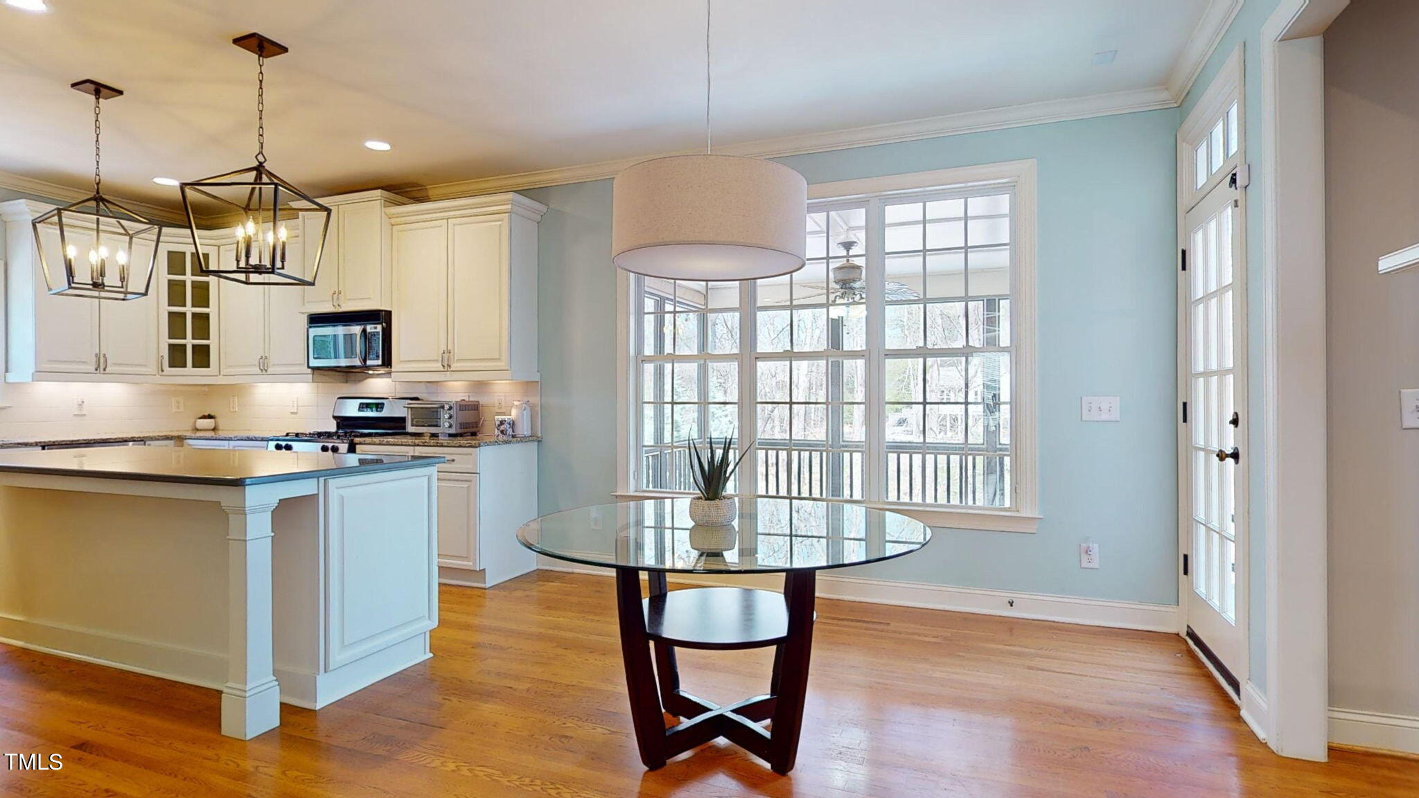 9306 Tabriz Point Raleigh, NC 27614 - Photo 14 of 46 a kitchen with stainless steel appliances granite countertop a stove and a wooden floor