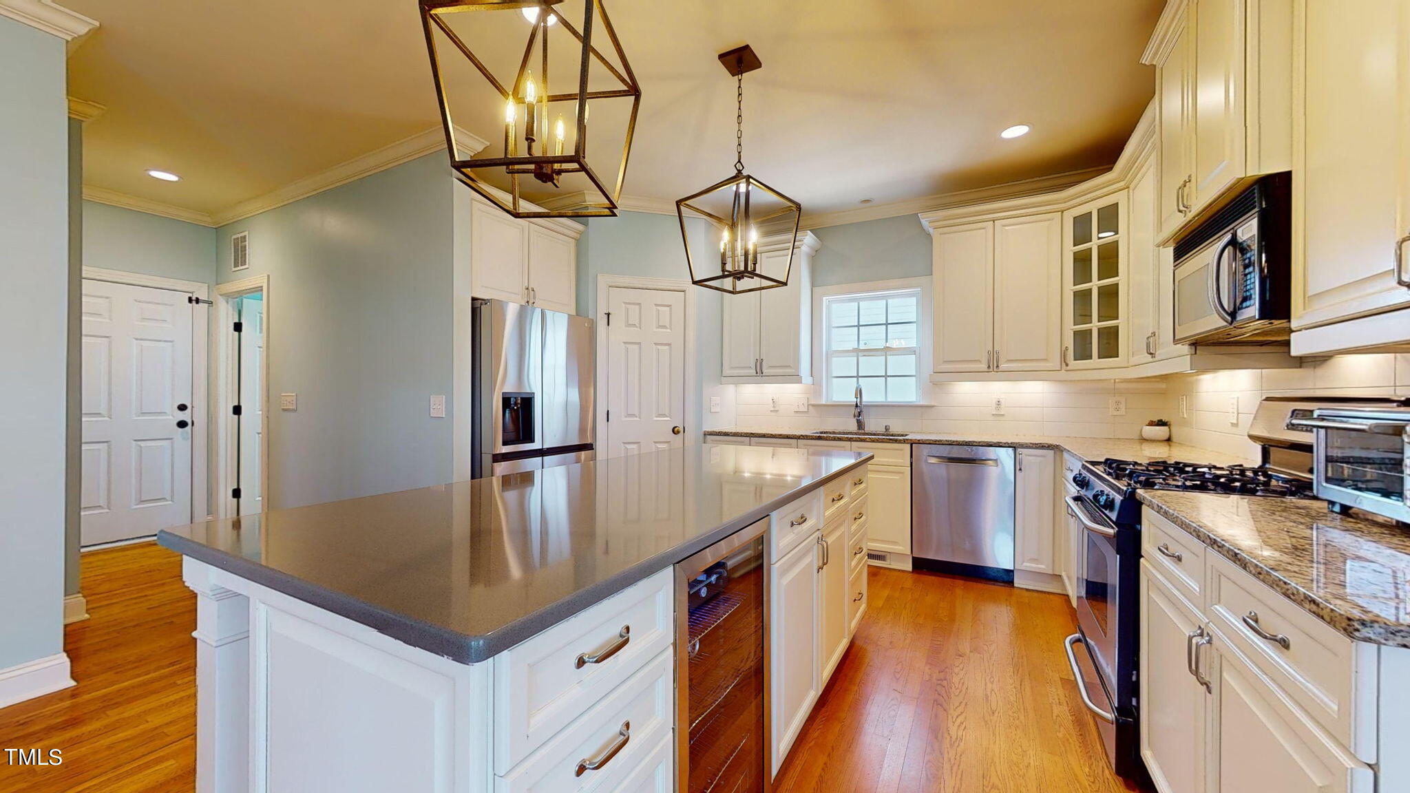9306 Tabriz Point Raleigh, NC 27614 - Photo 15 of 46 a kitchen with stainless steel appliances granite countertop a sink a stove top oven a counter space and cabinets
