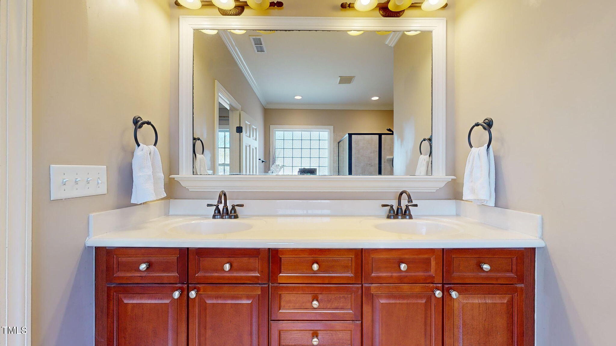 9306 Tabriz Point Raleigh, NC 27614 - Photo 23 of 46 a bathroom with a double vanity sink and a mirror