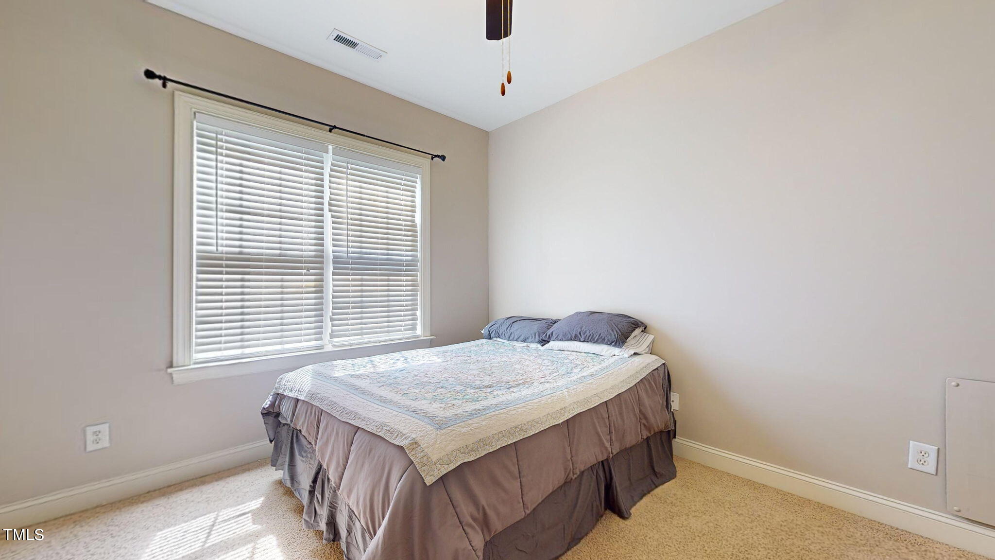 9306 Tabriz Point Raleigh, NC 27614 - Photo 30 of 46 a bedroom with a bed and a window