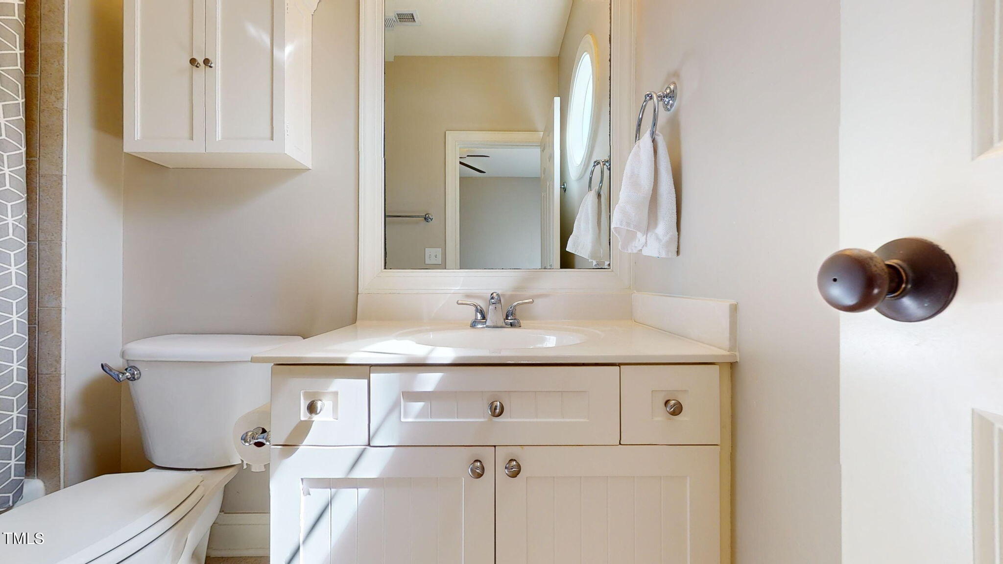 9306 Tabriz Point Raleigh, NC 27614 - Photo 31 of 46 a bathroom with a sink vanity mirror and toilet