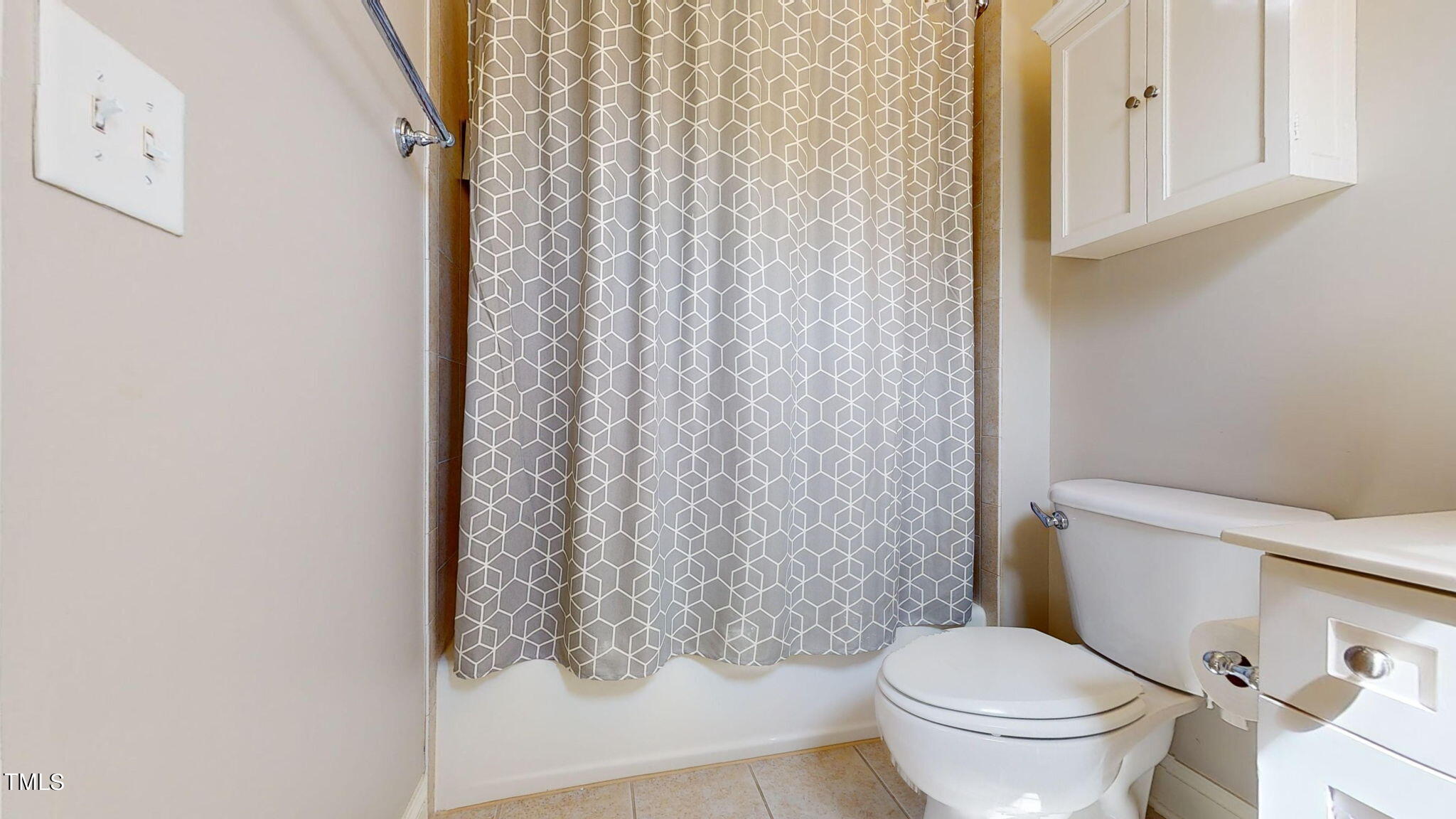9306 Tabriz Point Raleigh, NC 27614 - Photo 32 of 46 a white toilet sitting next to a shower curtain