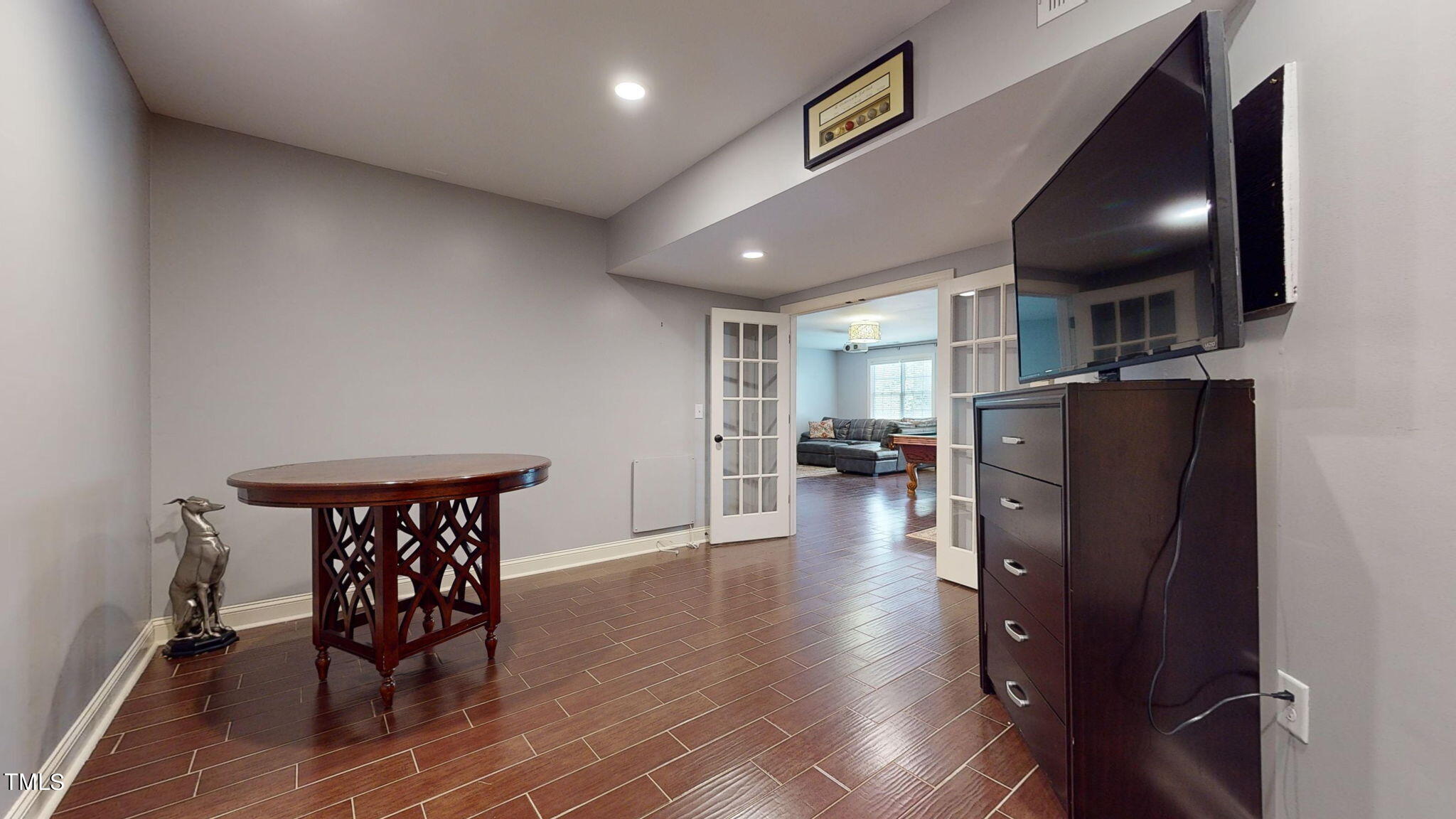 9306 Tabriz Point Raleigh, NC 27614 - Photo 35 of 46 a kitchen with stainless steel appliances granite countertop a refrigerator a stove a sink a dining table and chairs with wooden floor