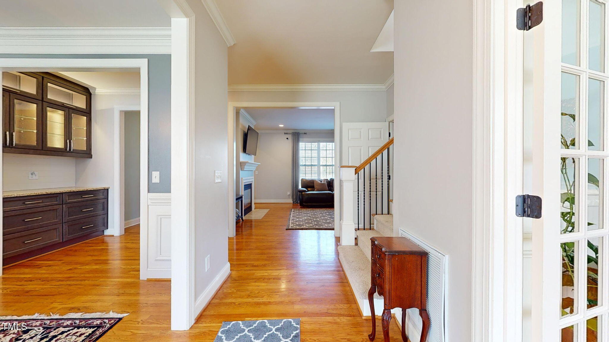 9306 Tabriz Point Raleigh, NC 27614 - Photo 7 of 46 a view of a hallway with wooden floor and staircase