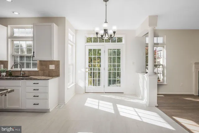 a view of a entryway with cabinet and chandelier