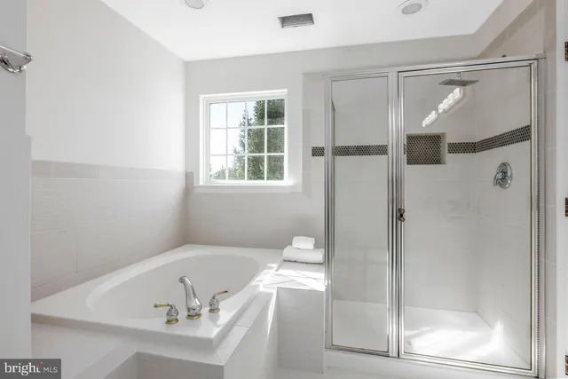a bathroom with a tub and a shower