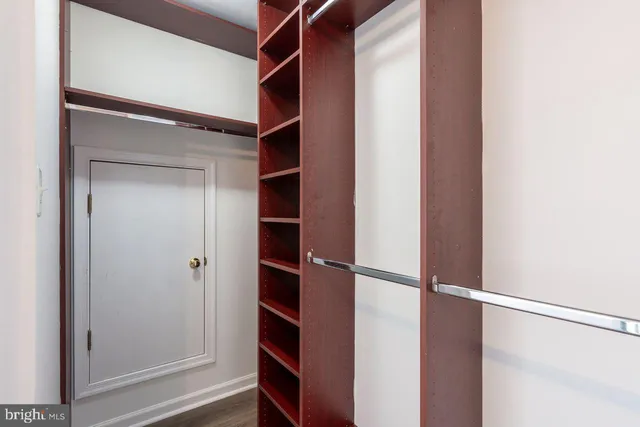 a view of walk in closet with empty racks