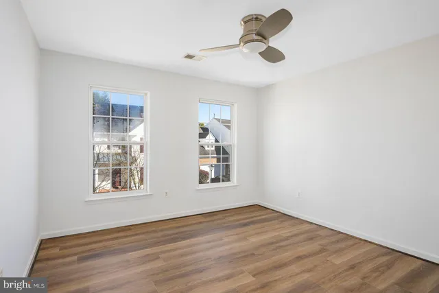 wooden floor in an empty room with a window