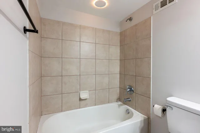 a bathroom with a bathtub and toilet