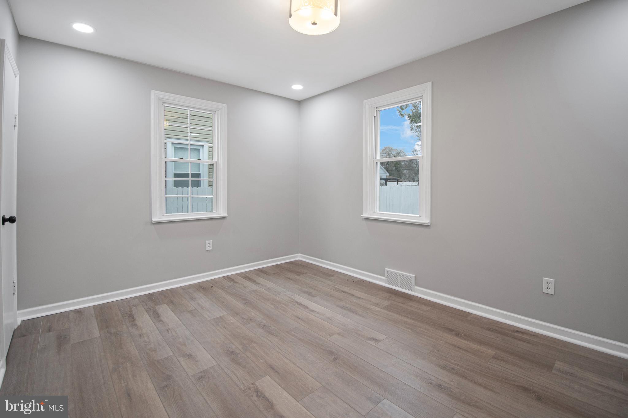 331 Westmoreland Drive Ewing, NJ 08618 - Photo 18 of 28 an empty room with wooden floor and windows