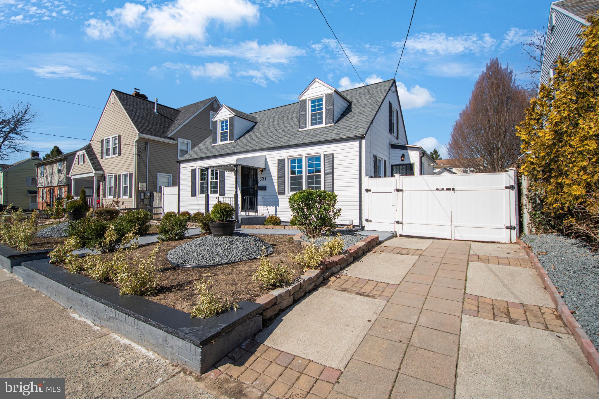 331 Westmoreland Drive Ewing, NJ 08618 - Photo 4 of 28 a view of a white house with a small yard and large tree
