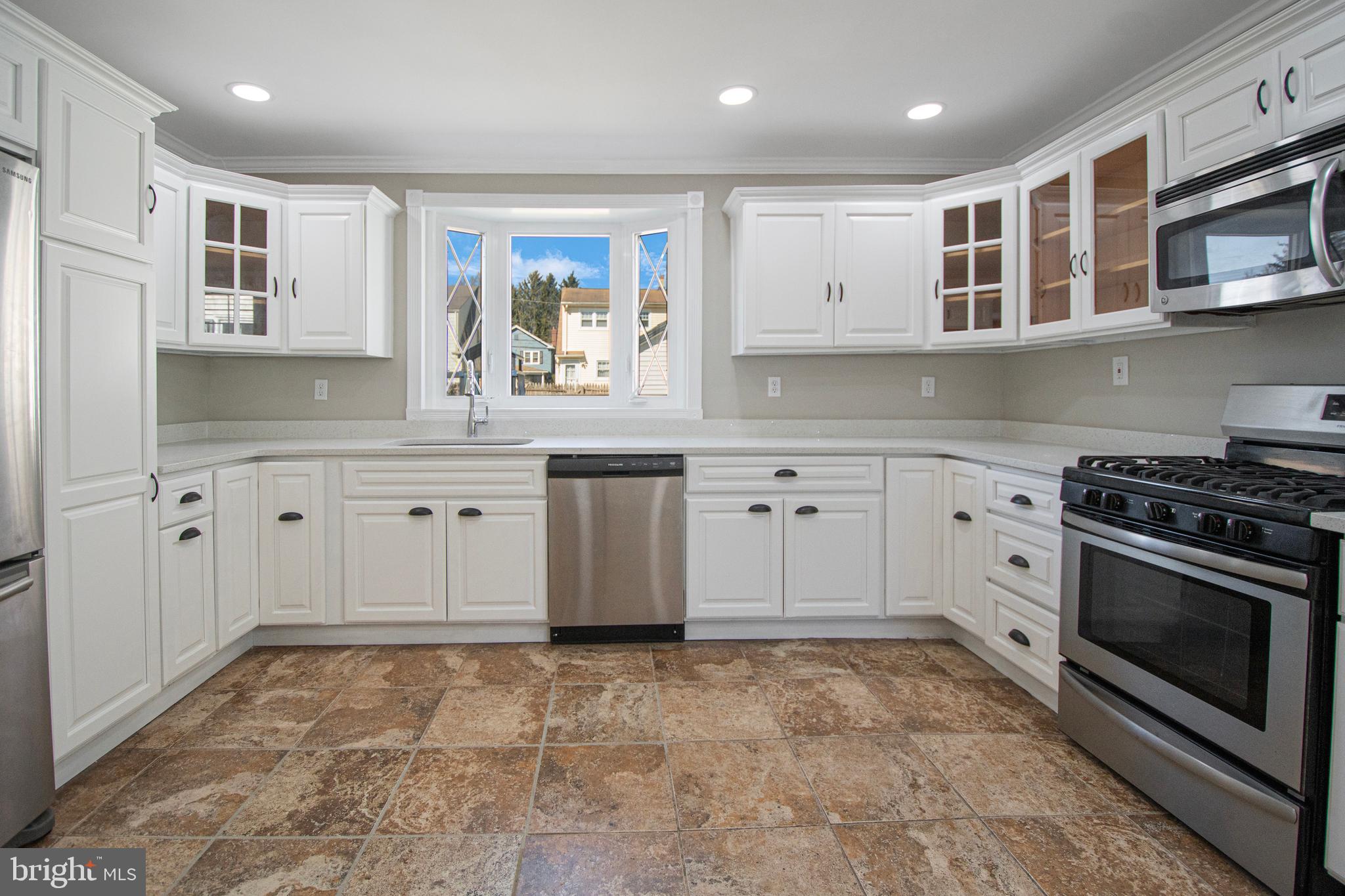 331 Westmoreland Drive Ewing, NJ 08618 - Photo 9 of 28 a kitchen with stainless steel appliances a stove sink and cabinets