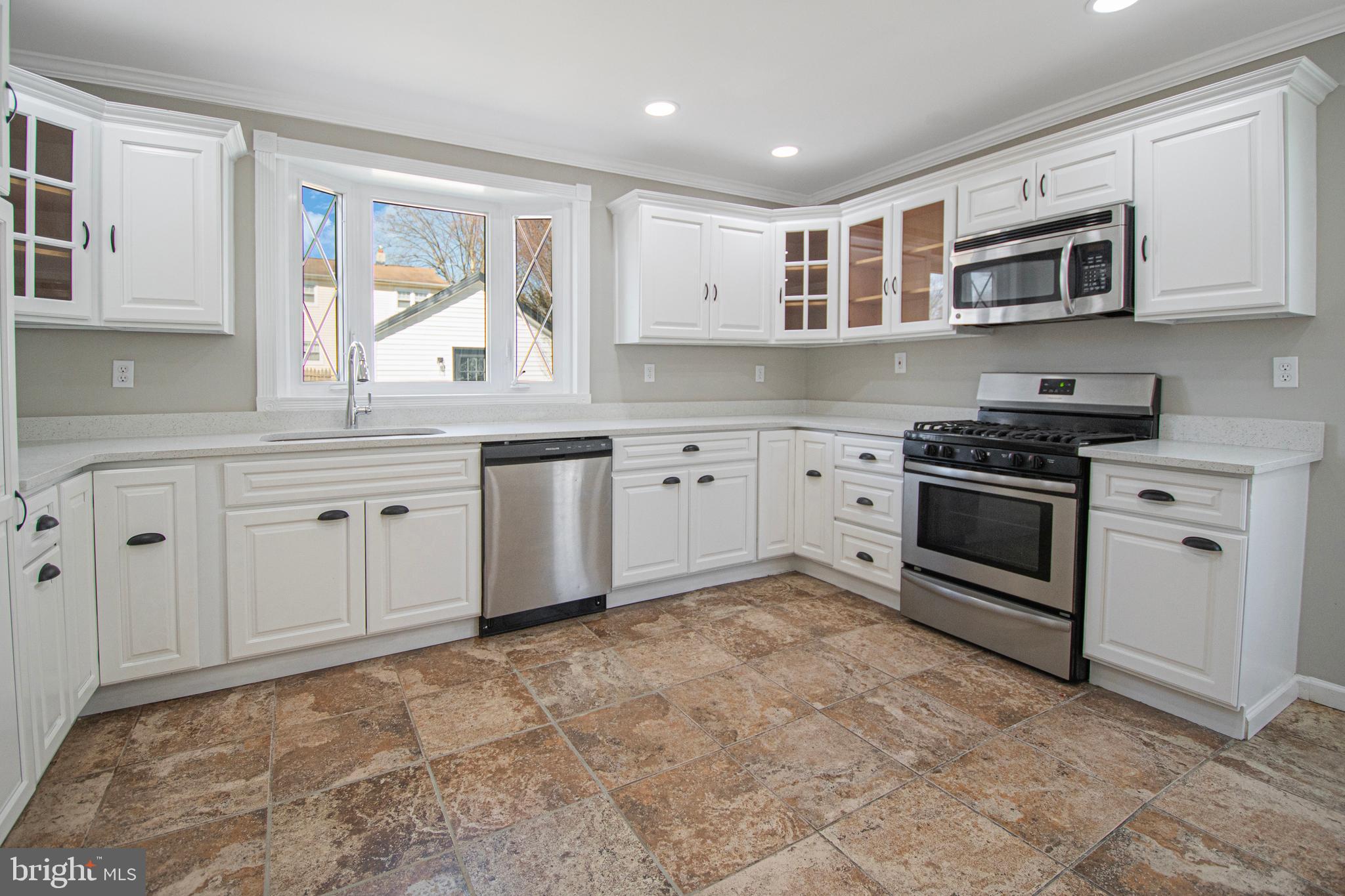 331 Westmoreland Drive Ewing, NJ 08618 - Photo 10 of 28 a kitchen with granite countertop a stove top oven sink and cabinets