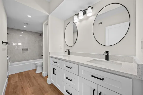 a bathroom with a sink a toilet and a mirror