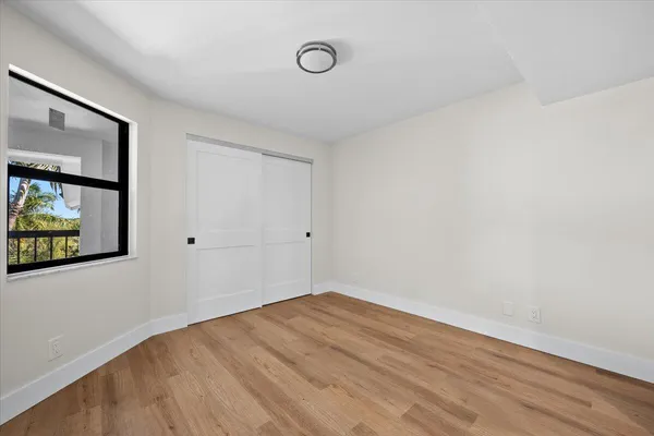a view of a room with wooden floor and window