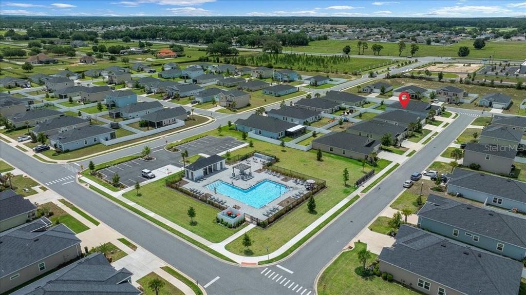 9329 Southwest 57th Terrace Ocala, FL 34476 - Photo 52 of 64 an aerial view of a city with lots of residential buildings and mountain view in back