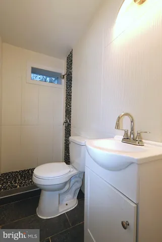 a bathroom with a sink toilet and a mirror