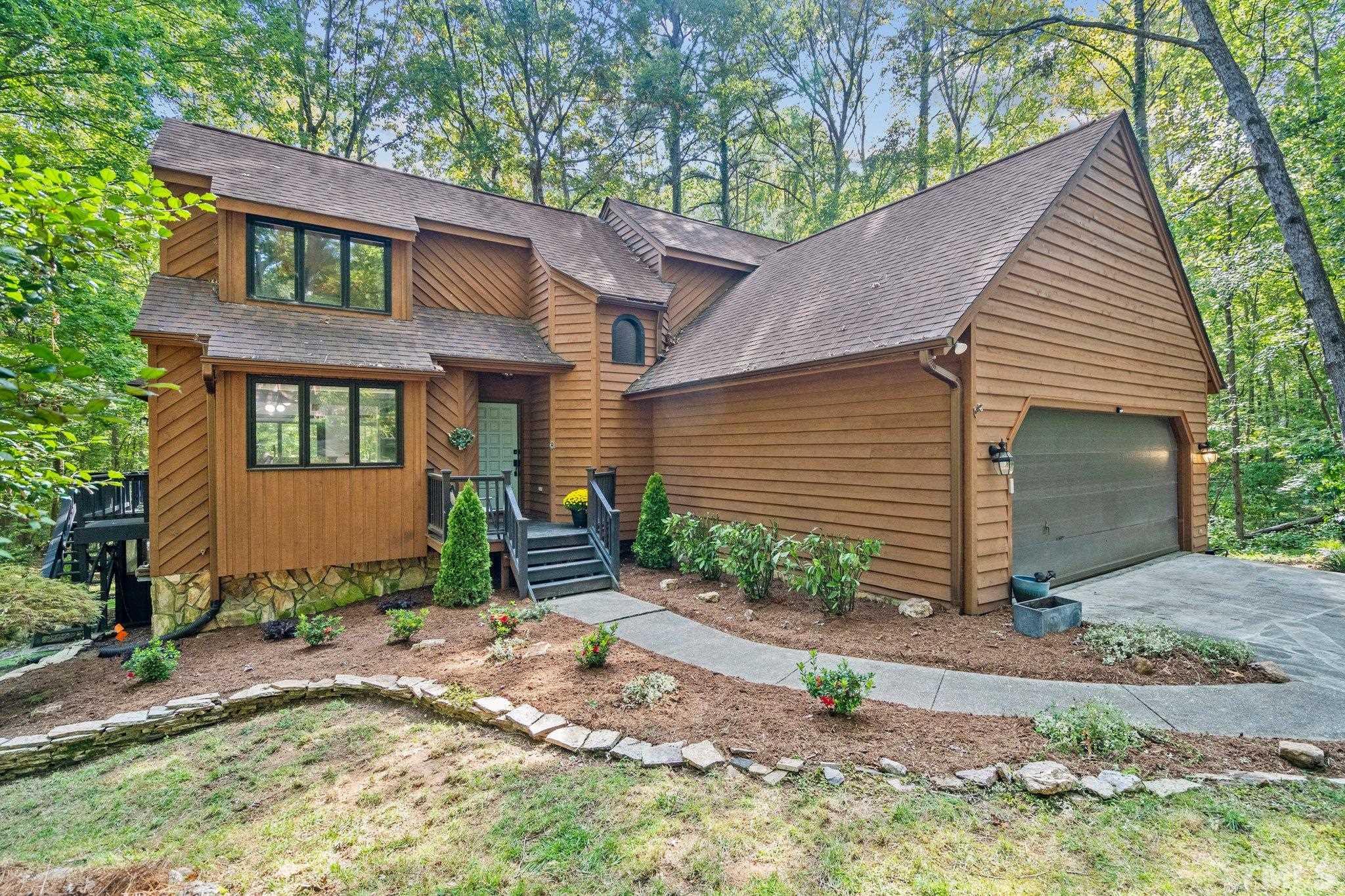 6509 Deerview Drive Raleigh, NC 27606 - Photo 1 of 36 a front view of a house with garden