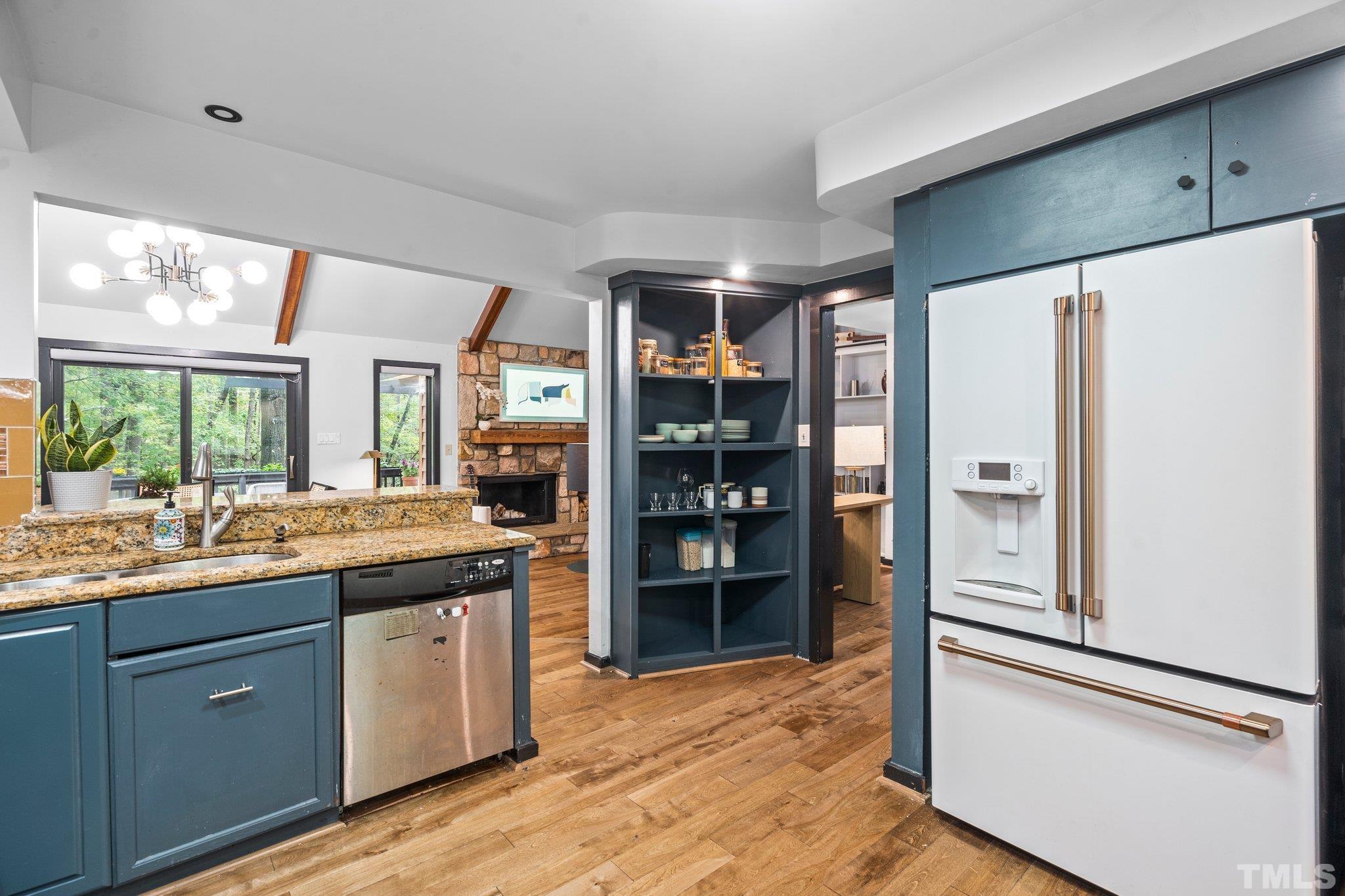 6509 Deerview Drive Raleigh, NC 27606 - Photo 11 of 36 a kitchen with stainless steel appliances granite countertop a refrigerator and a sink