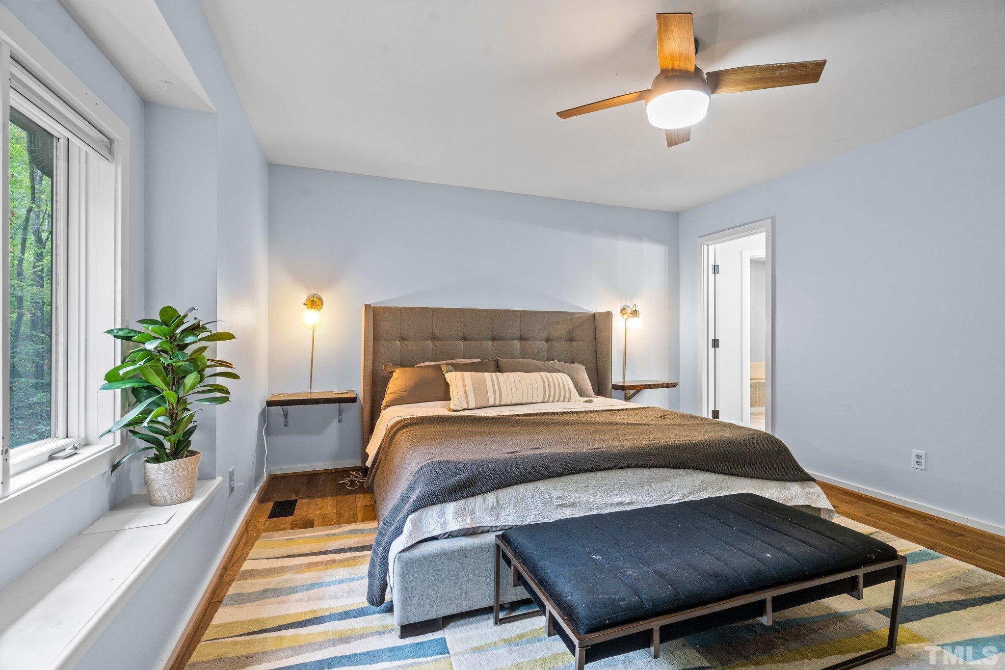 6509 Deerview Drive Raleigh, NC 27606 - Photo 12 of 36 a bedroom with a bed and a potted plant