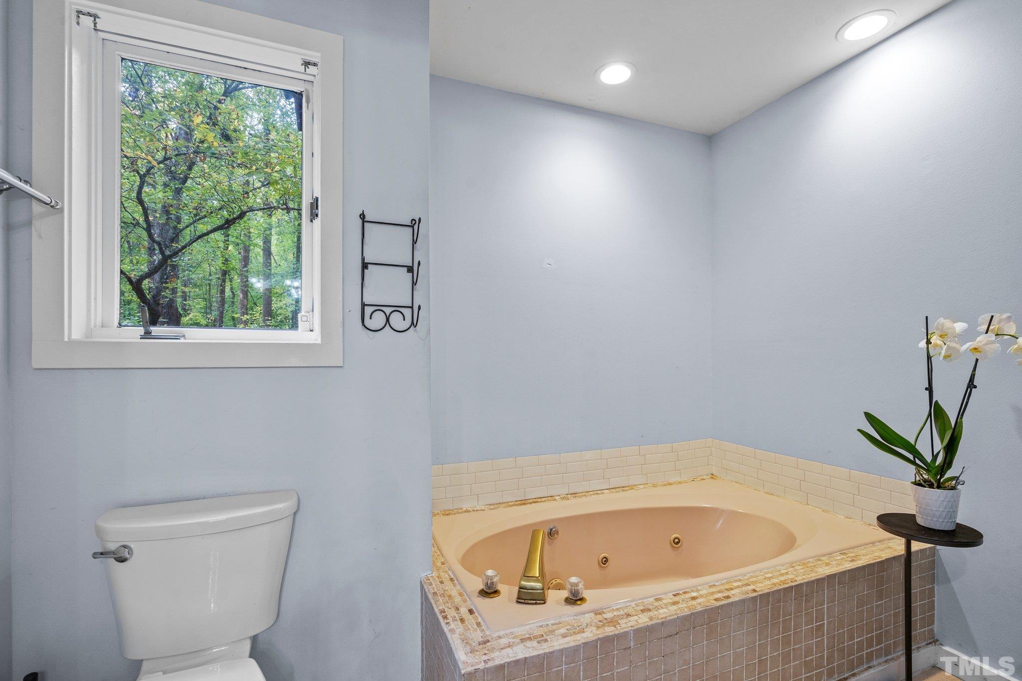 6509 Deerview Drive Raleigh, NC 27606 - Photo 16 of 36 a white bath tub sitting next to a toilet