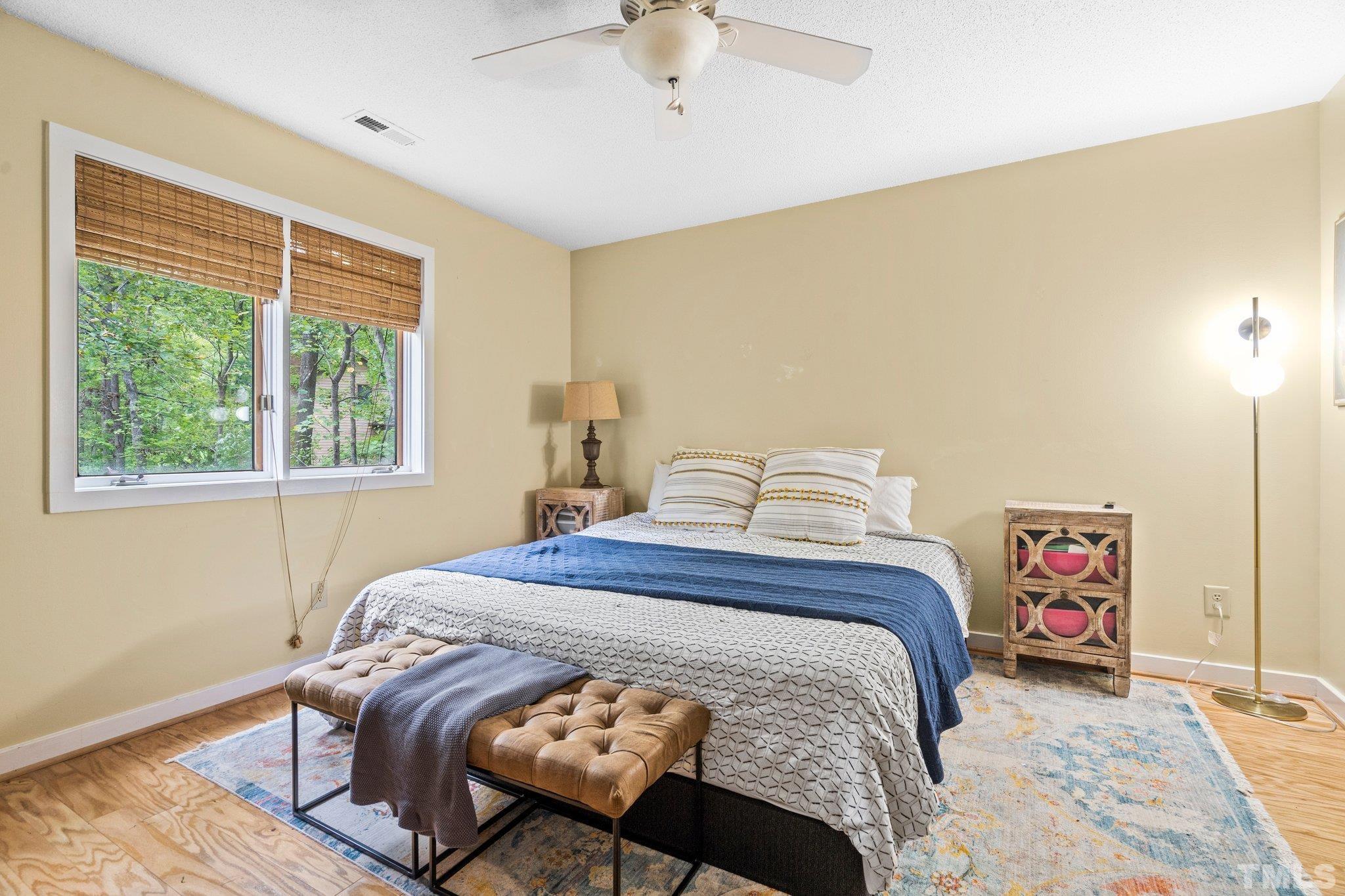 6509 Deerview Drive Raleigh, NC 27606 - Photo 19 of 36 a bedroom with a bed and a window