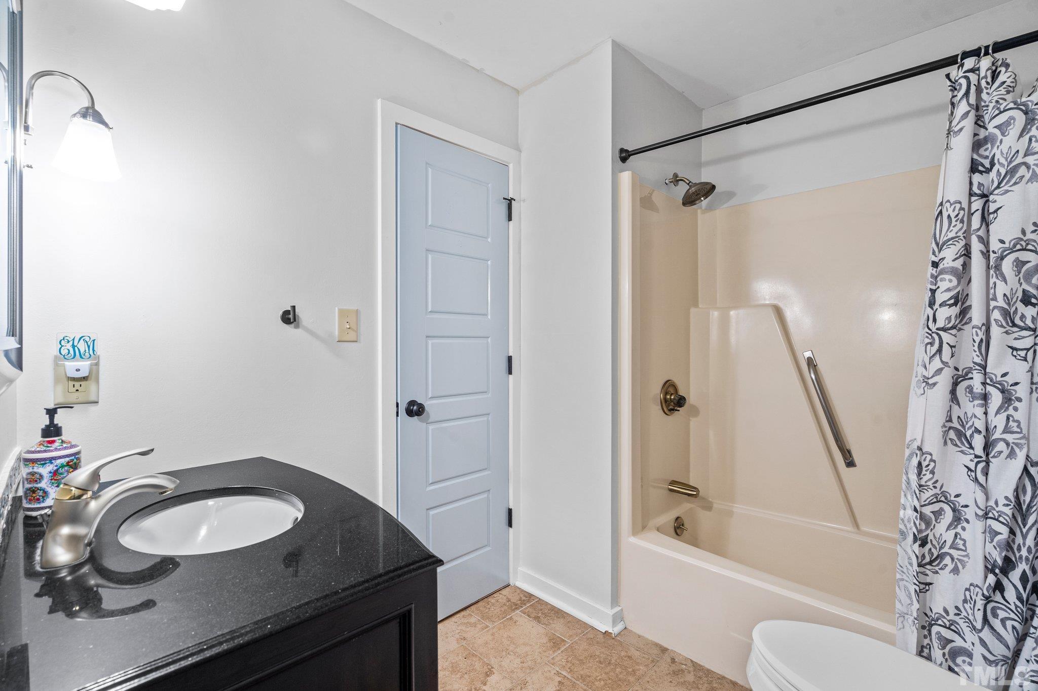 6509 Deerview Drive Raleigh, NC 27606 - Photo 21 of 36 a bathroom with a sink and a mirror