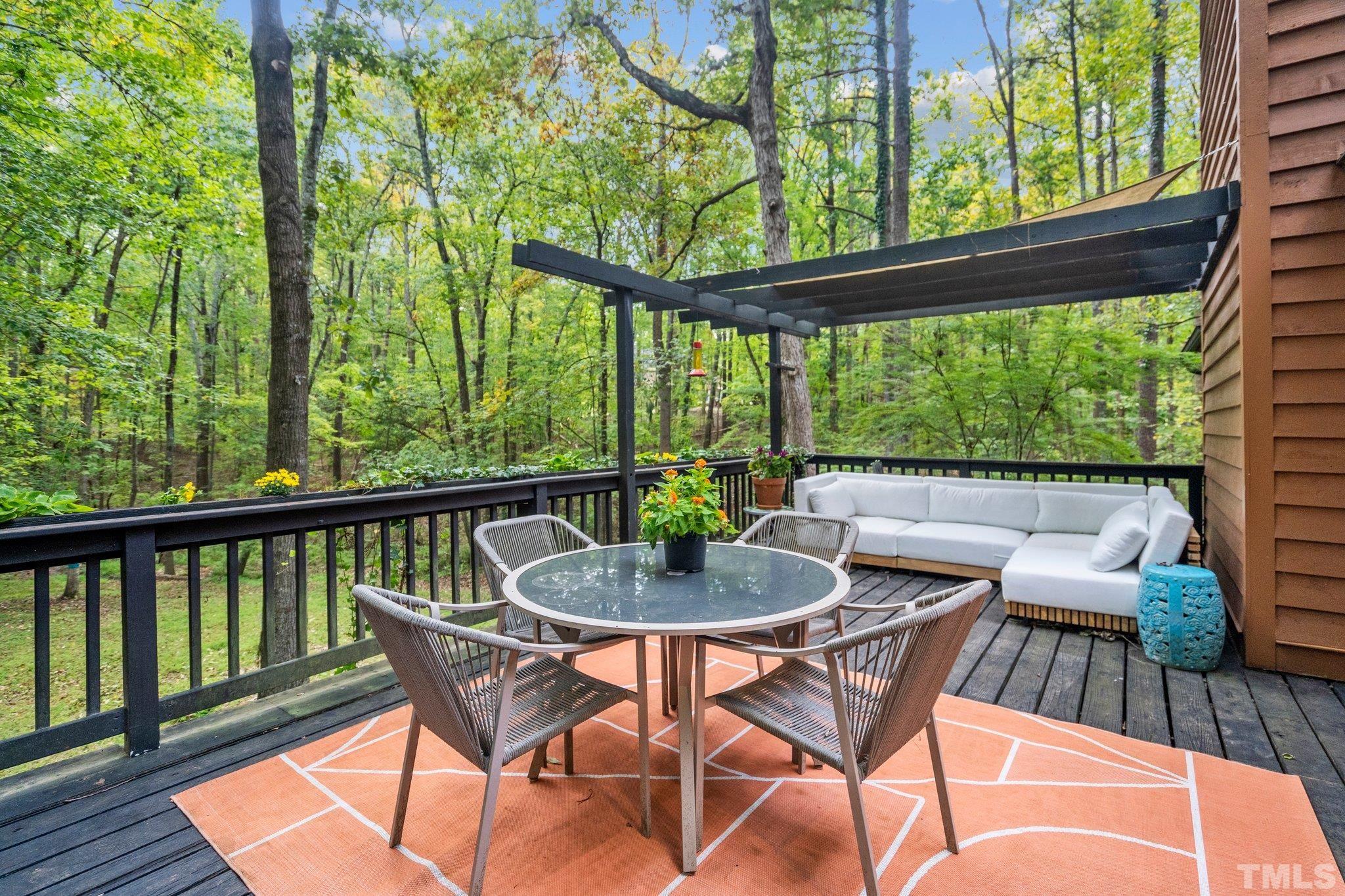 6509 Deerview Drive Raleigh, NC 27606 - Photo 27 of 36 a view of a patio with a table chairs and a small yard