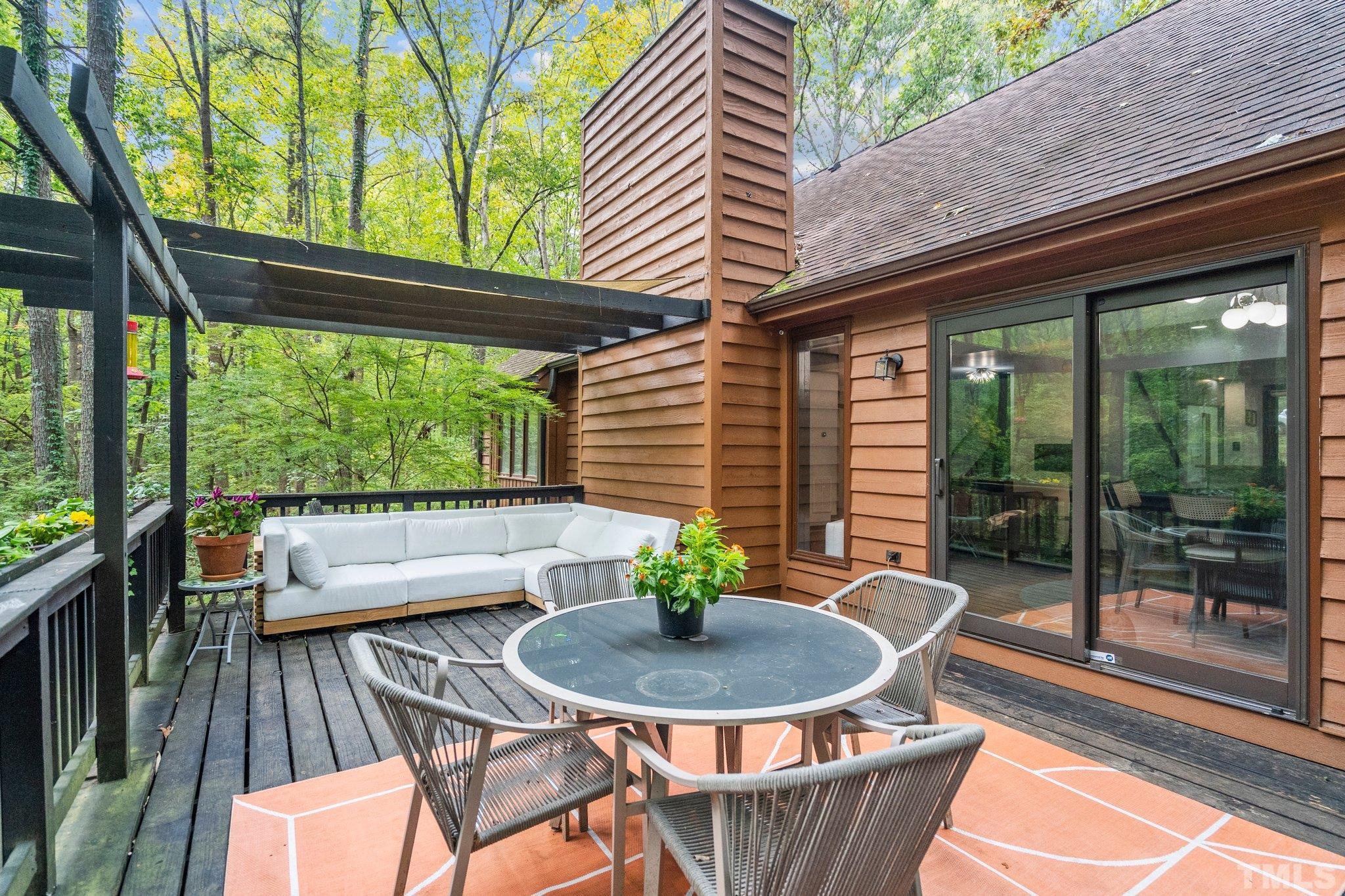 6509 Deerview Drive Raleigh, NC 27606 - Photo 28 of 36 a view of a patio with a table chairs and a backyard