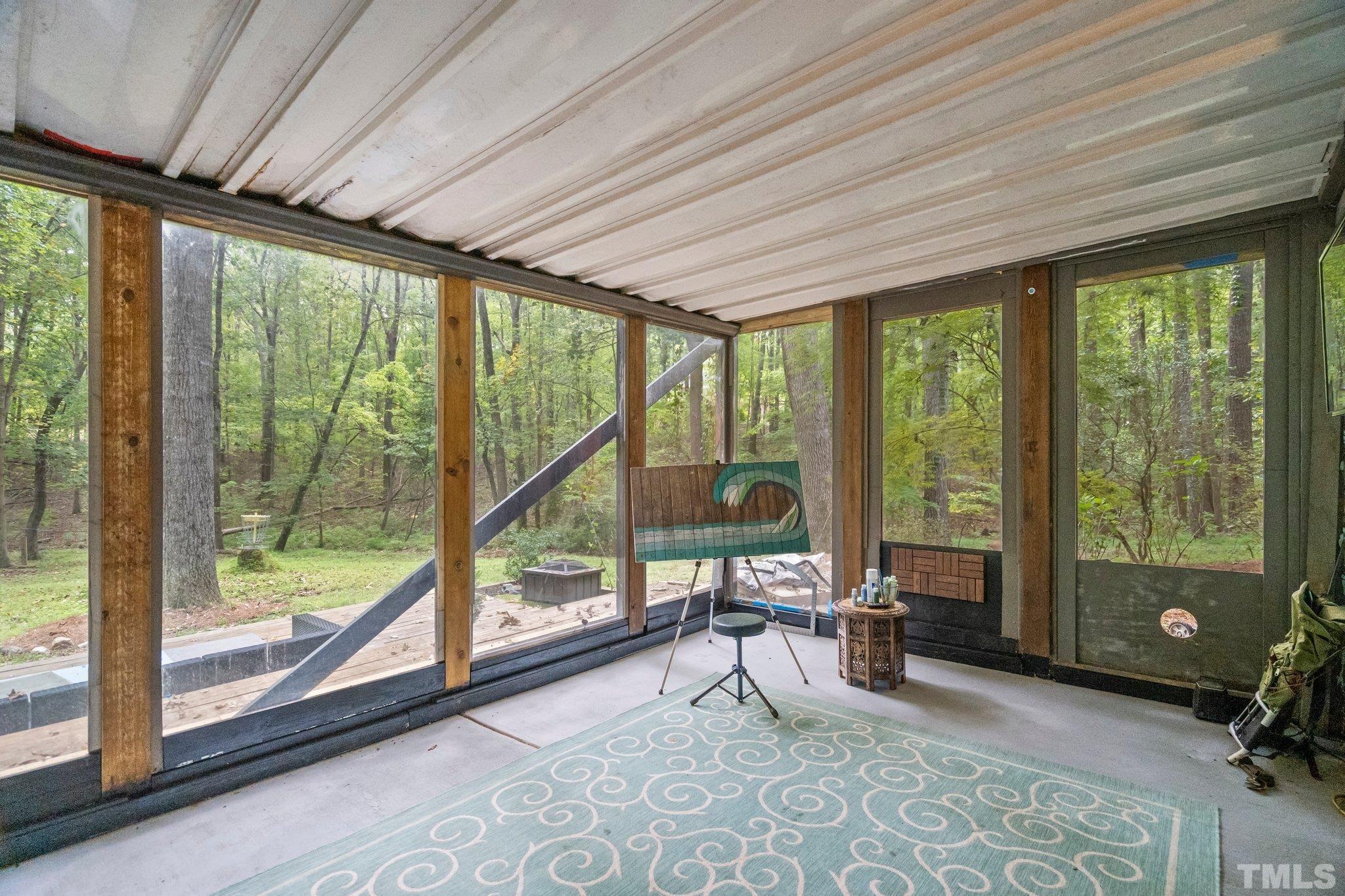6509 Deerview Drive Raleigh, NC 27606 - Photo 29 of 36 a living room with furniture and floor to ceiling windows