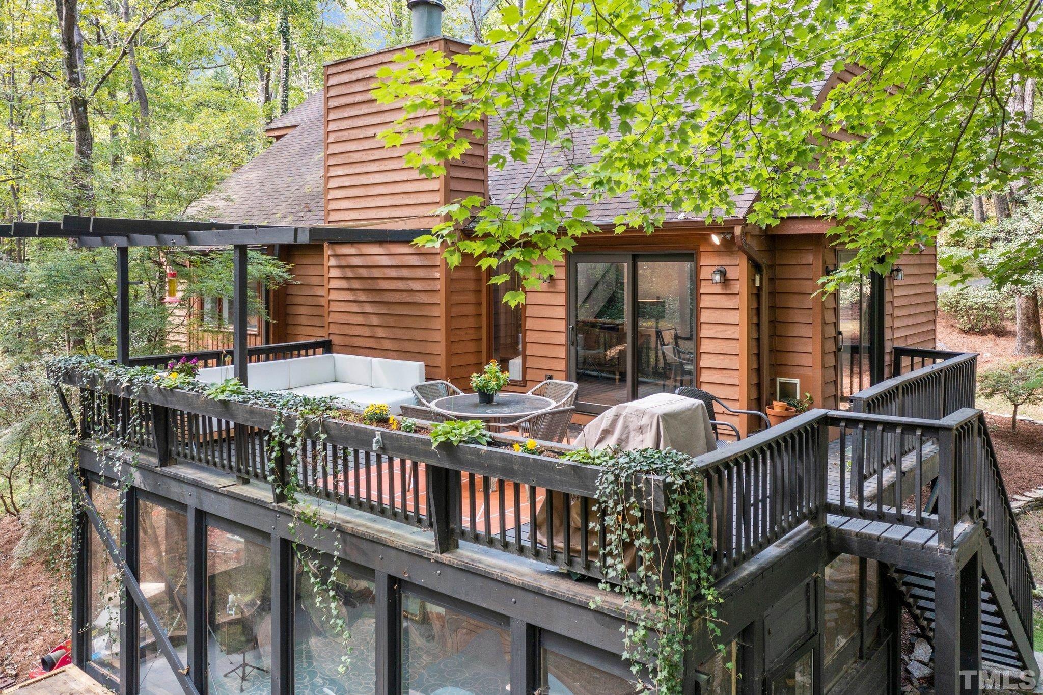 6509 Deerview Drive Raleigh, NC 27606 - Photo 34 of 36 a front view of house with deck and outdoor seating