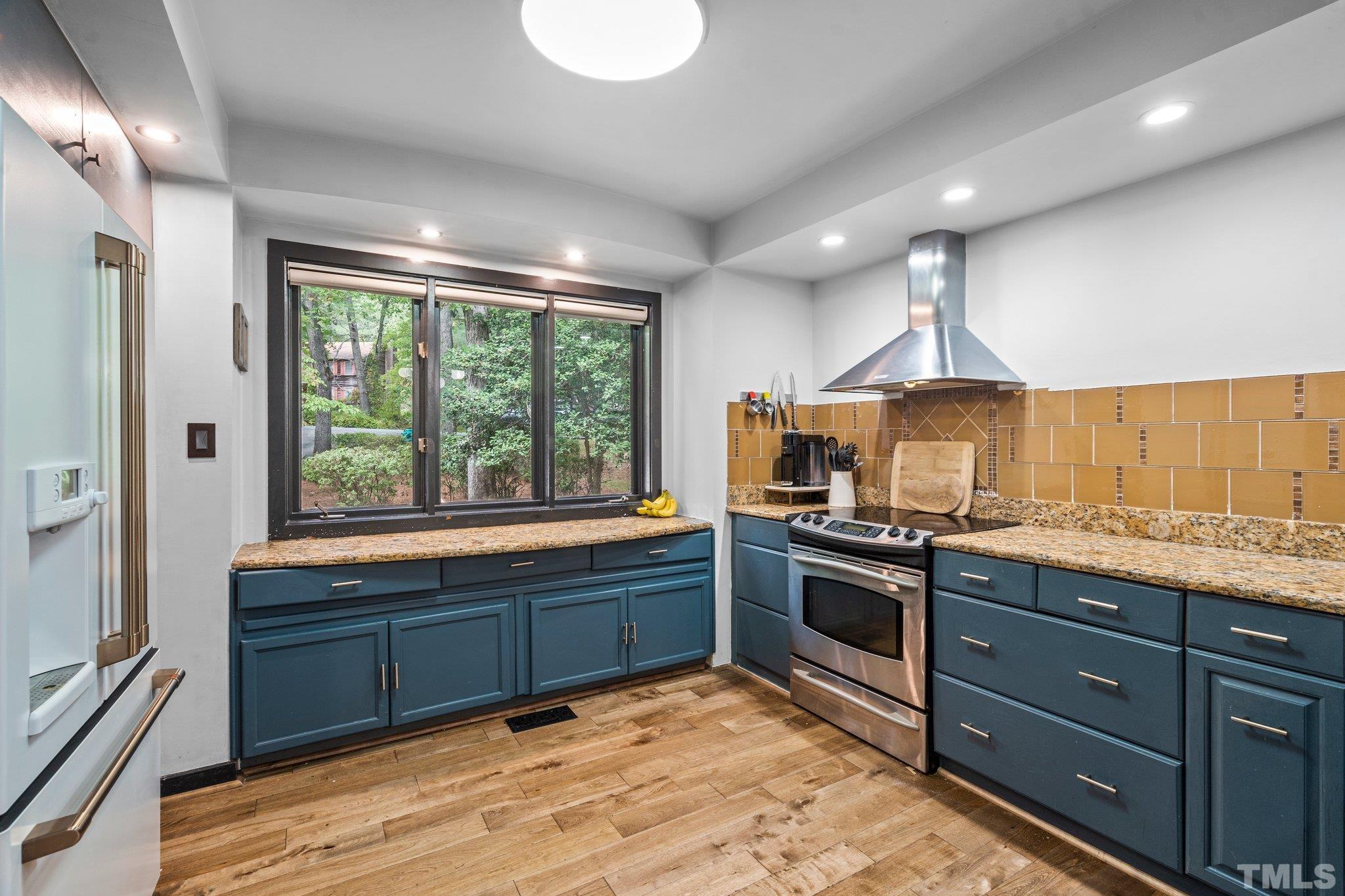 6509 Deerview Drive Raleigh, NC 27606 - Photo 9 of 36 a kitchen with stainless steel appliances granite countertop a stove and a sink