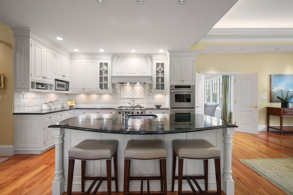 1 Old Farm Road Wellesley, MA 02481 - Photo 20 of 41 a kitchen with kitchen island granite countertop a table and chairs in it